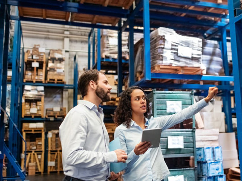 a image showing two warehouse managers in the warehouse for reference